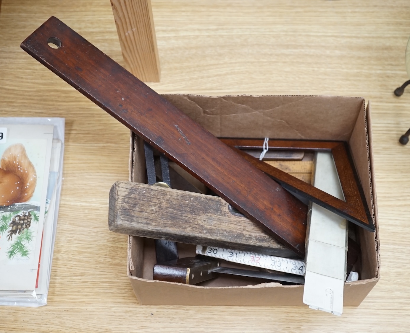 A collection of 19th and 20th century drawing instruments, including; levels, rulers, a set square etc. longest 79cm. Condition - variable, mostly fair to good